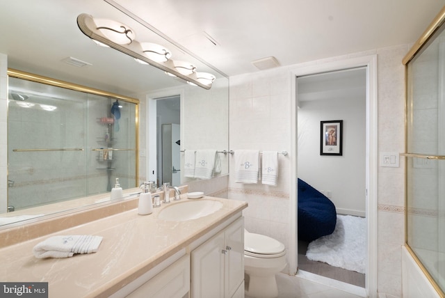 bathroom featuring vanity, tile patterned flooring, and toilet