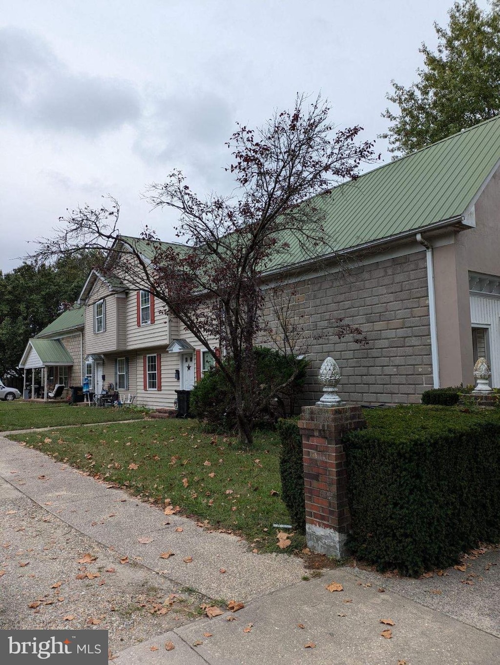 view of side of home with a yard