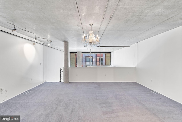 basement featuring carpet floors and a chandelier