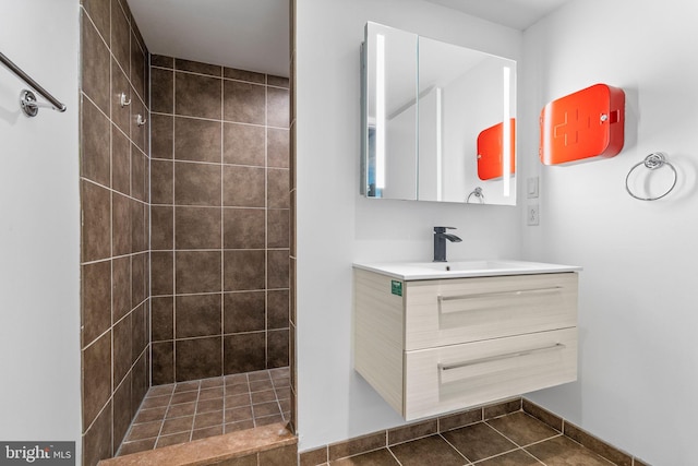 bathroom with vanity, tile patterned floors, and tiled shower