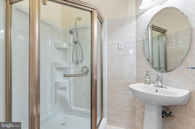 bathroom with tile walls and tiled shower