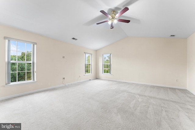 carpeted empty room with ceiling fan and lofted ceiling