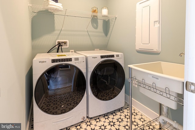 clothes washing area with light tile patterned floors and separate washer and dryer