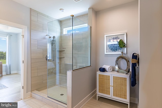 bathroom with hardwood / wood-style floors and a shower with shower door