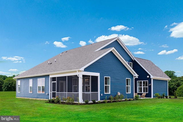 back of property featuring a sunroom and a yard