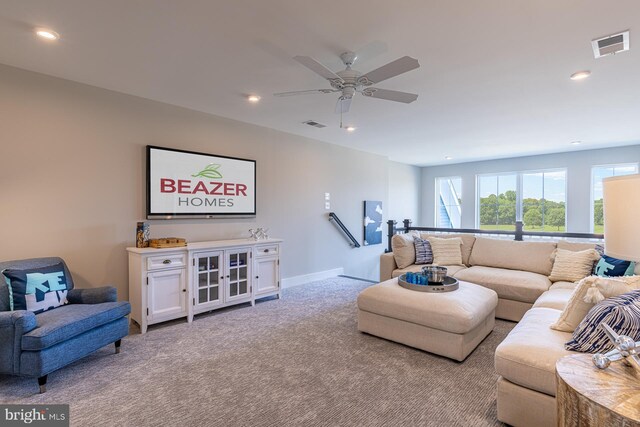 carpeted living room with ceiling fan