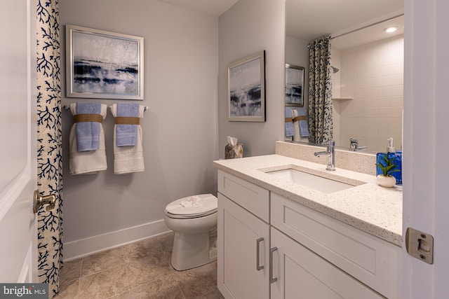 bathroom with vanity, toilet, and curtained shower