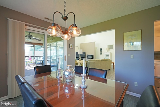 dining area featuring ceiling fan, a textured ceiling, and hardwood / wood-style floors