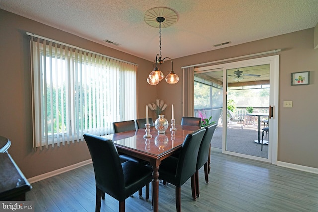 dining area featuring a textured ceiling, hardwood / wood-style flooring, and ceiling fan