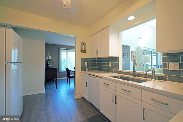 kitchen with white appliances, dark wood-type flooring, sink, and white cabinets