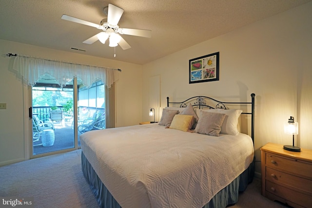 bedroom featuring dark carpet, a textured ceiling, access to outside, and ceiling fan