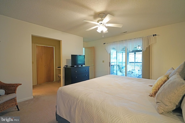 carpeted bedroom featuring ceiling fan, access to outside, and a textured ceiling