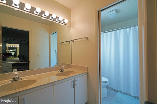 bathroom featuring vanity, toilet, and tile patterned floors