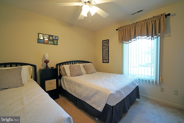 bedroom with ceiling fan and light carpet