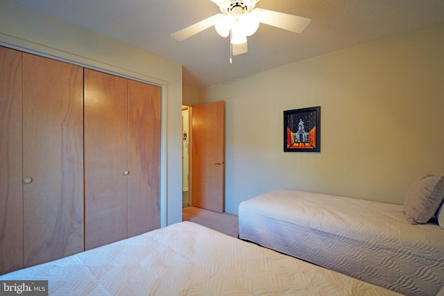 carpeted bedroom with a closet and ceiling fan