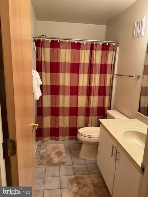 bathroom with vanity, toilet, tile patterned floors, and a shower with shower curtain