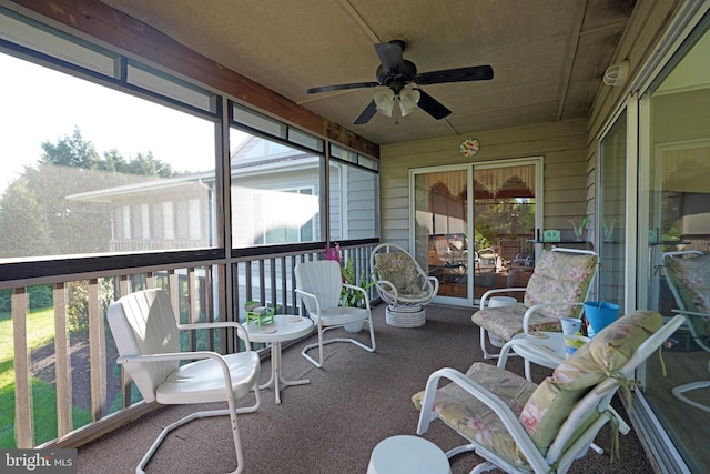 sunroom / solarium featuring ceiling fan