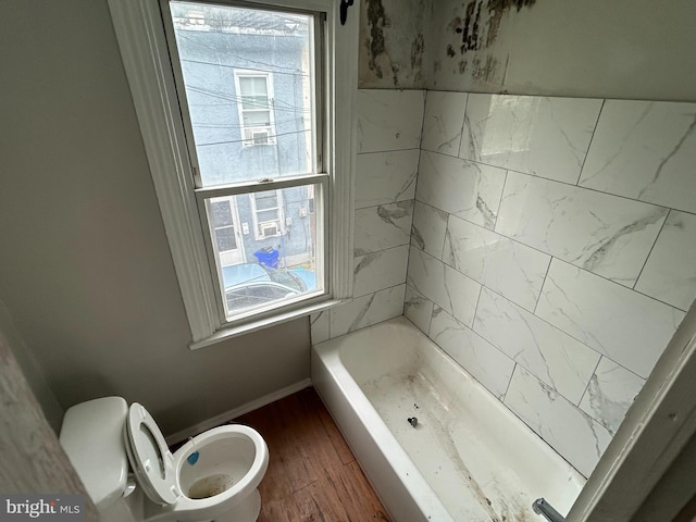 bathroom with a bathtub, hardwood / wood-style floors, toilet, and plenty of natural light