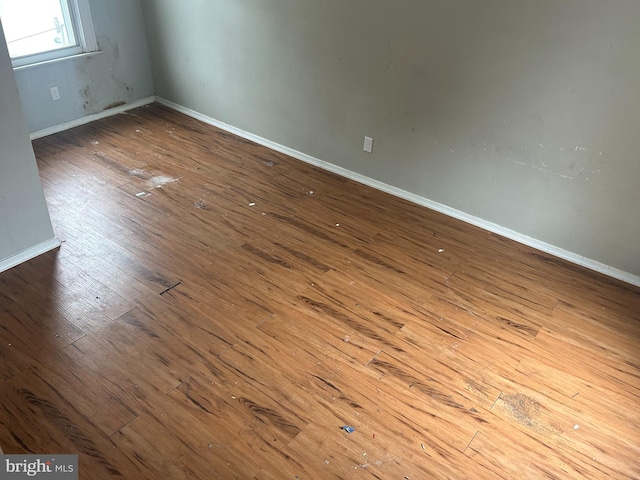 spare room with hardwood / wood-style floors