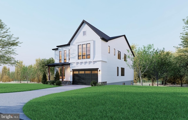 view of front of home with a front yard and a garage