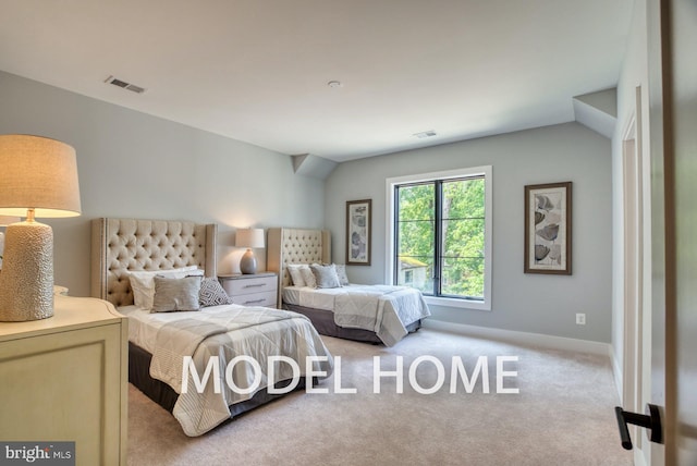 bedroom featuring vaulted ceiling and light carpet