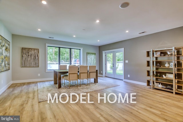 dining space featuring french doors and light hardwood / wood-style floors