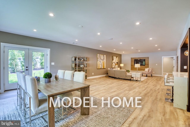 dining room featuring light hardwood / wood-style floors and french doors