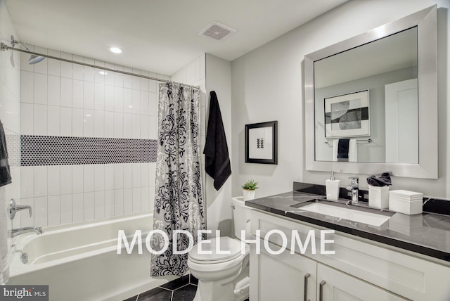 full bathroom with tile patterned floors, shower / bath combo, vanity, and toilet