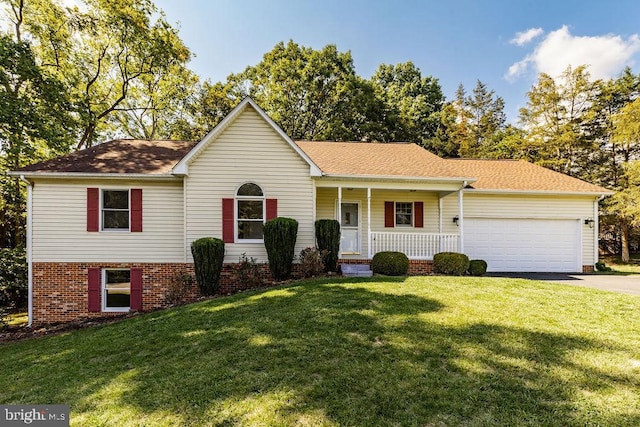 view of front of home featuring a garage, a porch, and a front lawn