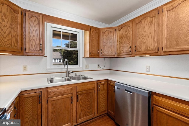 kitchen with crown molding, sink, hardwood / wood-style floors, and stainless steel dishwasher