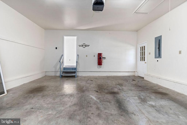 garage with a garage door opener and electric panel