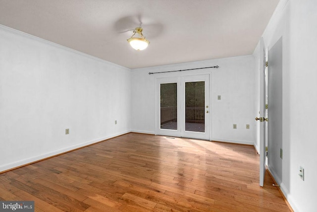 unfurnished room with crown molding and hardwood / wood-style flooring