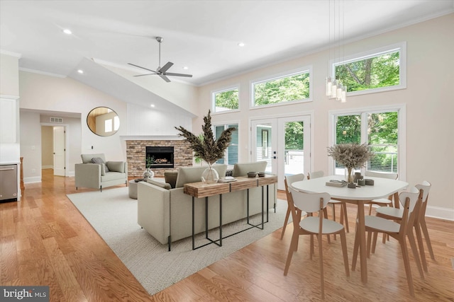 living room featuring crown molding, light hardwood / wood-style flooring, and french doors