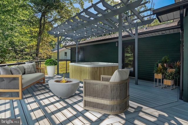 wooden terrace featuring an outdoor living space with a fire pit, a pergola, and a hot tub