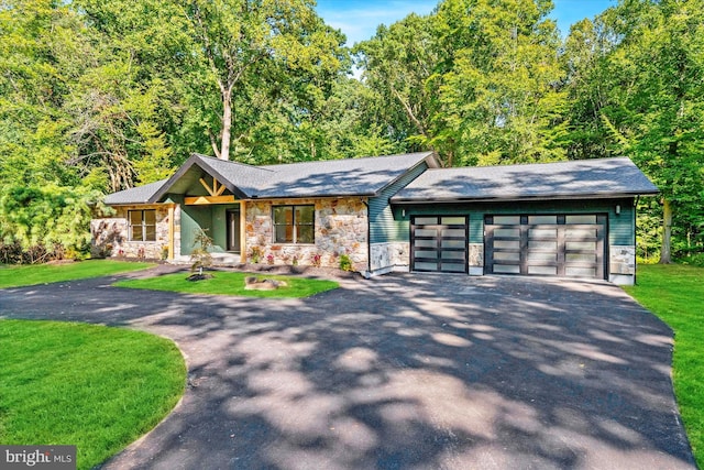 view of front of house with a garage and a front yard