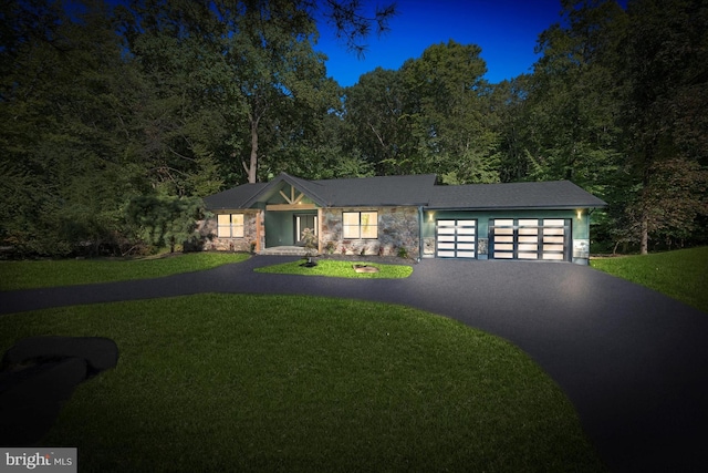 view of front of home with a garage and a front lawn