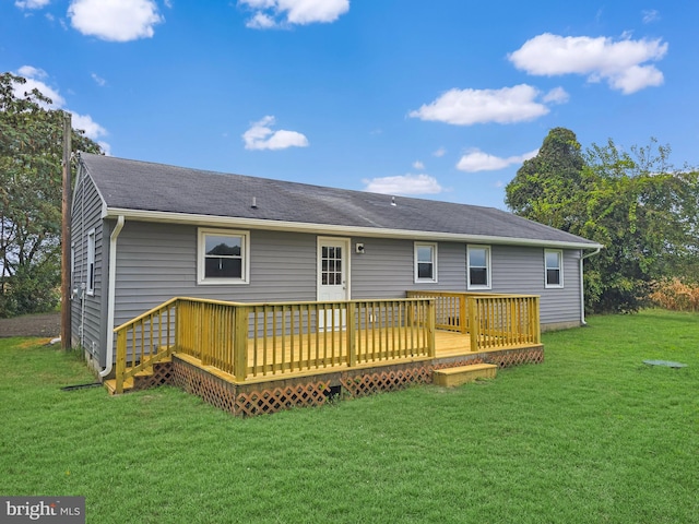 back of property featuring a deck and a yard