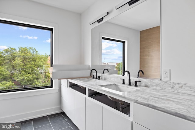 706 Latona St Unit F, Philadelphia, PA 19147 - kitchen with a sink, light stone counters, white cabinetry, and plenty of natural light