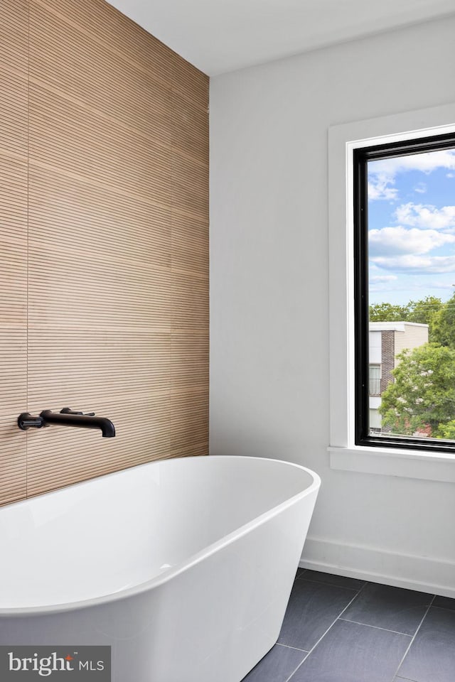 706 Latona St Unit F, Philadelphia, PA 19147 - bathroom featuring a soaking tub, tile patterned floors, and baseboards