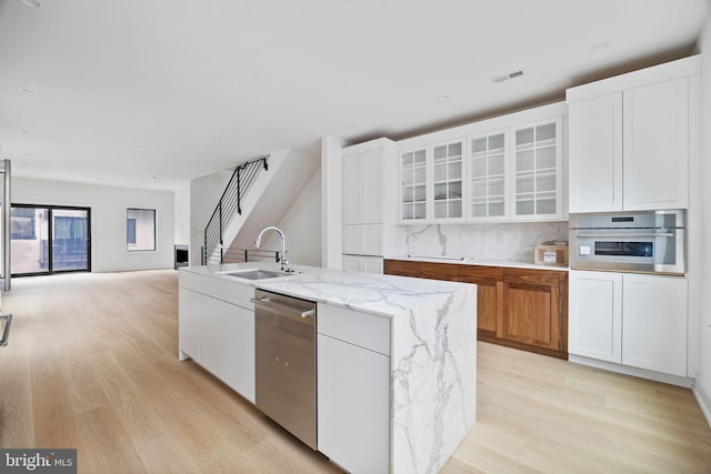 706 Latona St Unit F, Philadelphia, PA 19147 - kitchen with stainless steel appliances, light wood-type flooring, a sink, and white cabinets
