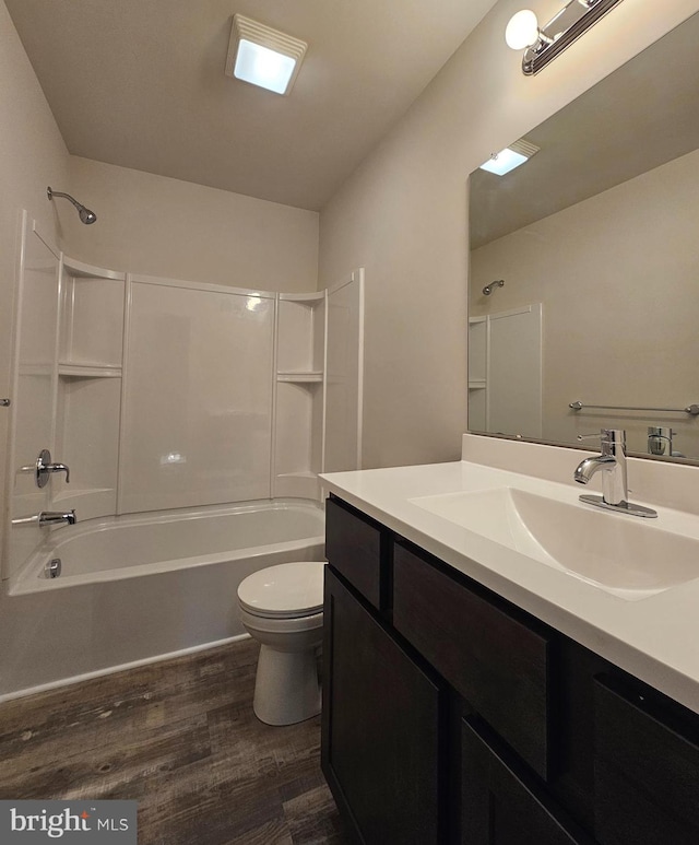 full bathroom featuring vanity, toilet, shower / washtub combination, and hardwood / wood-style flooring