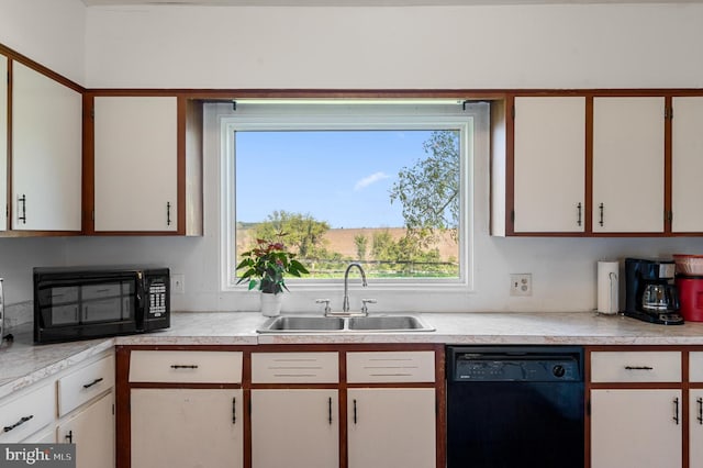 kitchen featuring black appliances, sink, and white cabinets