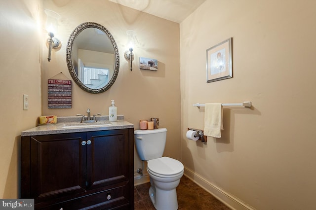 bathroom featuring toilet, vanity, and tile patterned flooring