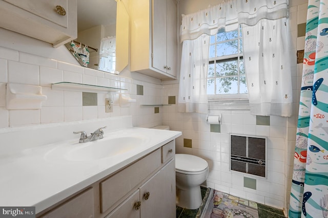 bathroom with toilet, vanity, curtained shower, heating unit, and tile walls