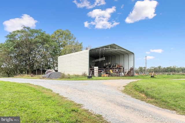 view of outdoor structure with a yard and a carport