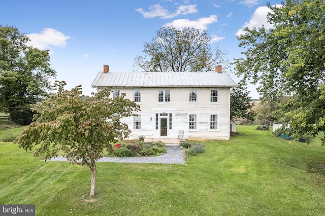 rear view of property featuring a patio area and a yard