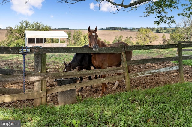 view of stable featuring a rural view