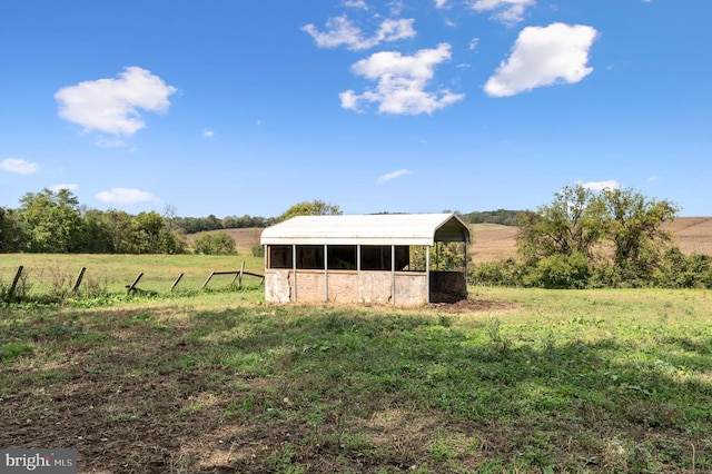 view of yard featuring an outbuilding and a rural view