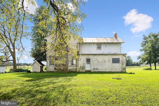 rear view of property with a yard