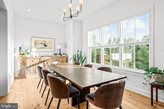 dining room featuring a notable chandelier and light hardwood / wood-style floors